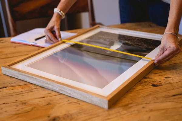 Expert framer assembling custom picture frame with precision tools Ottawa